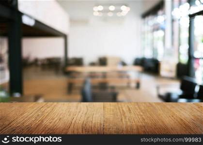 empty wood table in front of blur coffee shop / restaurant background, image can be place product