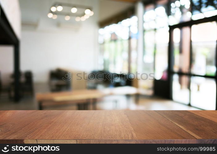 empty wood table in front of blur coffee shop / restaurant background, image can be place product