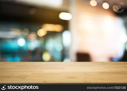 empty wood table in front of blurred coffee shop cafe background