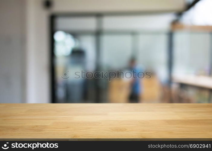 empty wood table in front of blurred coffee shop cafe or workplace background