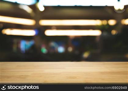 empty wood table in front of blurred coffee shop cafe or workplace background
