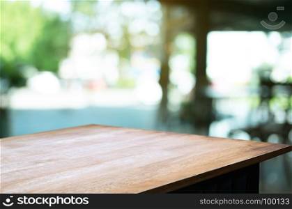 empty wood table in front of blurred montage home garden background