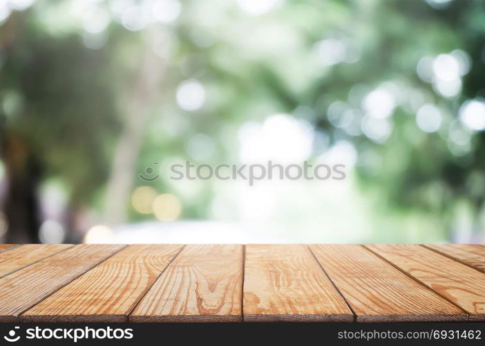 empty wood table in front of blurred montage nature in the garden background