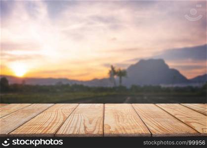 empty wood table in front of blurred montage wonderful mountain background