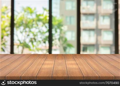 Empty wood table on blurred background copy space for montage your product or design , Blank brown board with abstract blurred background.