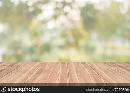 Empty wood table on blurred background copy space for montage your product or design,Blank brown board with abstract blurred background