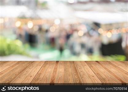 Empty wood table on blurred background copy space for montage your product or design,Blank brown board with abstract blurred background.