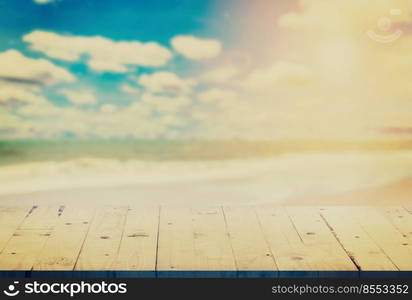 empty wood table on blurred sand beach with vintage effect.