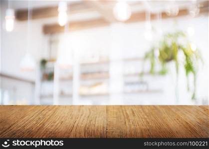 empty wood table over blurred montage coffee shop or kitchen background