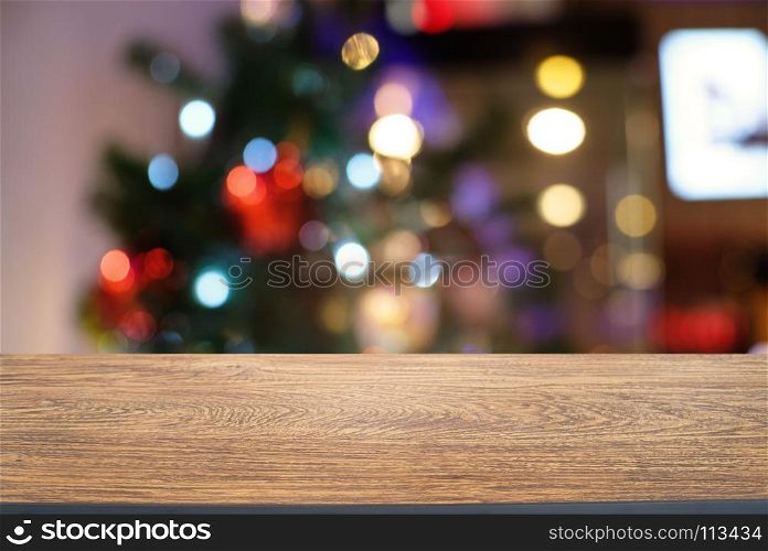 Empty wood table top and blur of glittering shine bulbs night light christmas New Year Celebration. background/selective focus .For montage product display xmas holiday festival backdrop