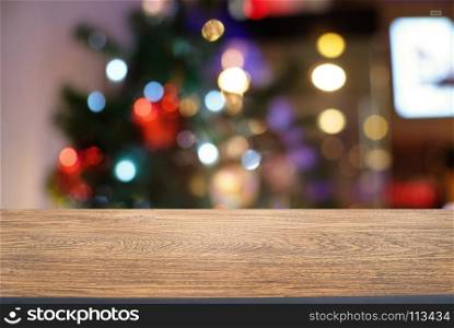 Empty wood table top and blur of glittering shine bulbs night light christmas New Year Celebration. background/selective focus .For montage product display xmas holiday festival backdrop