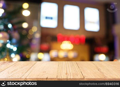 Empty wood table top and blur of glittering shine bulbs night light christmas New Year Celebration. background/selective focus .For montage product display xmas holiday festival backdrop