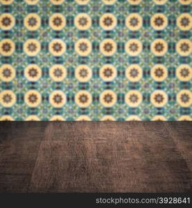 Empty wood table top and blur vintage ceramic tile pattern wall in background, Mock up template for display of your product.