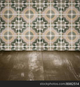 Empty wood table top and blur vintage ceramic tile pattern wall in background, Mock up template for display of your product.