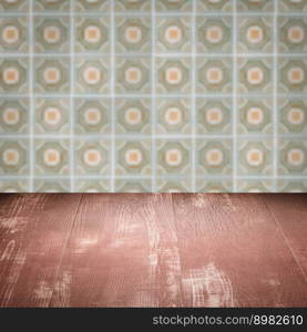 Empty wood table top and blur vintage ceramic tile pattern wall in background, Mock up template for display of your product.