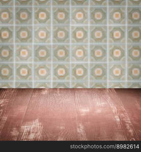 Empty wood table top and blur vintage ceramic tile pattern wall in background, Mock up template for display of your product.