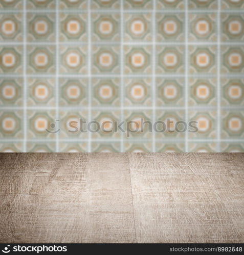 Empty wood table top and blur vintage ceramic tile pattern wall in background, Mock up template for display of your product.