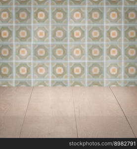 Empty wood table top and blur vintage ceramic tile pattern wall in background, Mock up template for display of your product.