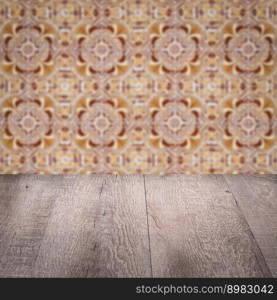 Empty wood table top and blur vintage ceramic tile pattern wall in background, Mock up template for display of your product.