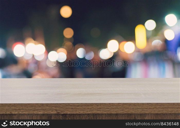 Empty wood table top for product display montage and blurred bokeh night. 