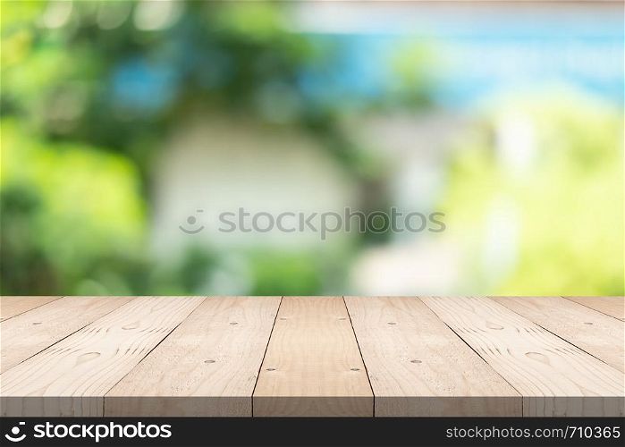 Empty wood table top on blured background at garden in shopping mall, copy space for montage you product