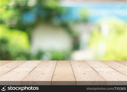 Empty wood table top on blured background at garden in shopping mall, copy space for montage you product