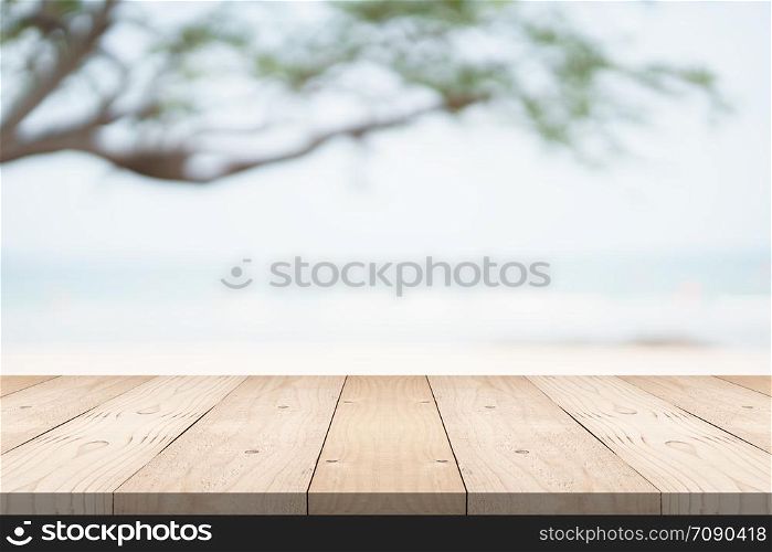 Empty wood table top on green background at the beach
