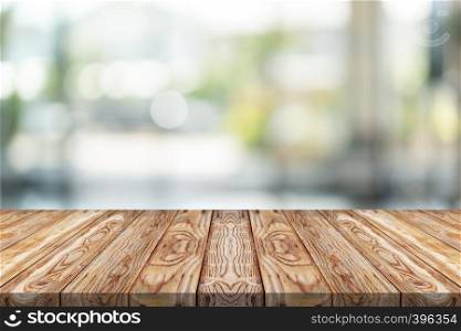 Empty wood table top on green blur background at shopping mall