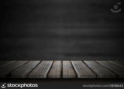 Empty wood table top over blur blackboard background.