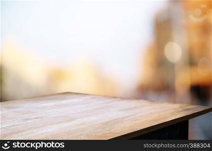 empty wood table top over blur in restaurant cafe background.