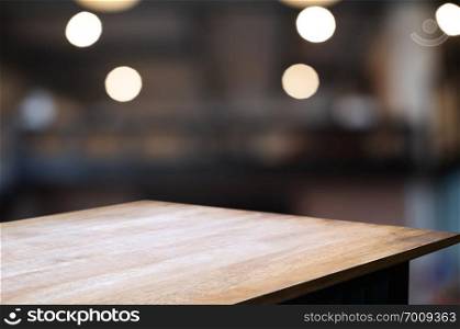 empty wood table with blur montage coffee shop cafe background.