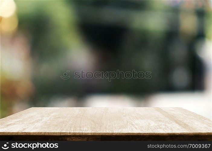 empty wood table with blur montage outdoor garden background.