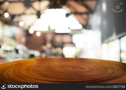 empty wood table with blurred coffee shop background.