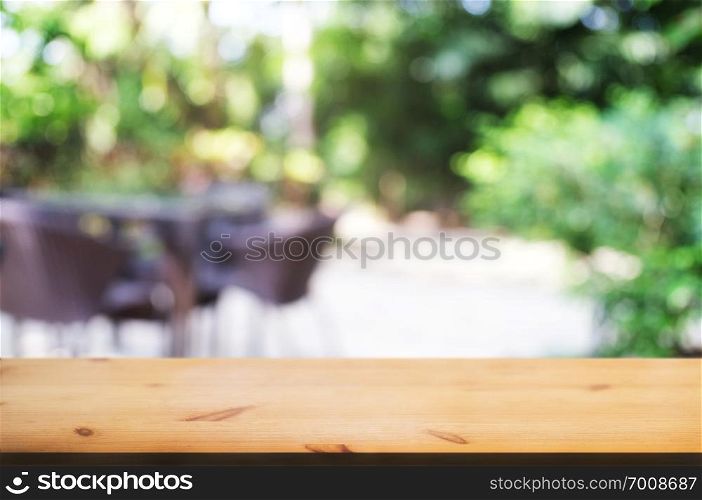 empty wood table with blurred montage nature green place background.