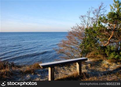 Empty wooden bench by the coast of the Baltic Sea at the swedish island Oland