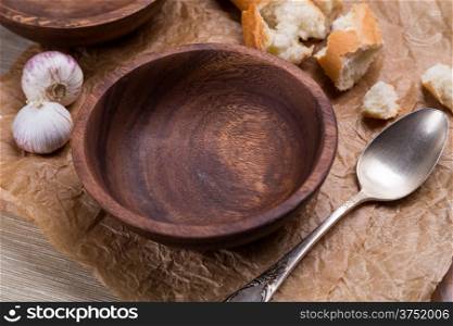 empty wooden bowl for soup on crushed brown paper