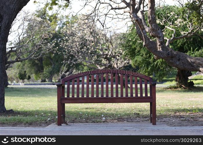 Empty wooden chair or old wood bench in the garden.. Empty wooden chair or old wood bench in the garden for concept of relaxation and emptiness.