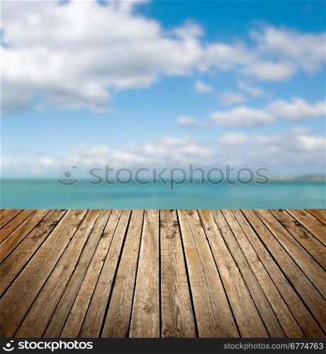 Empty wooden deck over sea and sky background