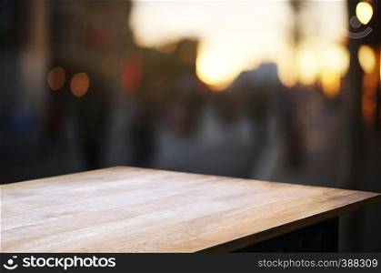 empty wooden deck, table top over blur outdoor market background.