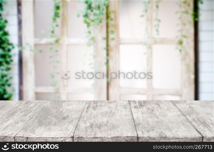 empty wooden desk over blurred interior decoration background.