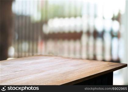 empty wooden desk over blurred interior decoration background