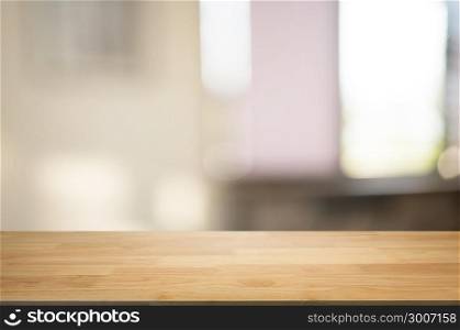 empty wooden desk over blurred montage coffee shop cafe / restaurant background