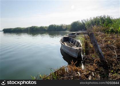 Empty wooden old boats in sunny day on the lake