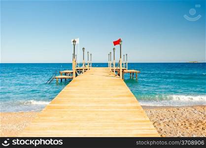 empty wooden pier stretching into the sea, shot at dawn