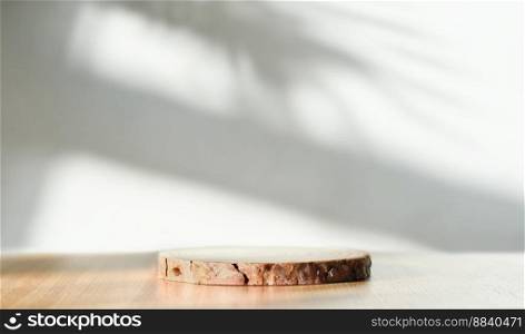 empty wooden round podium on a table and shadows on a wall. copy space for product presentation and sale promotion. empty wooden round podium on a table and shadows on a wall. copy space for product presentation and sale promotion.