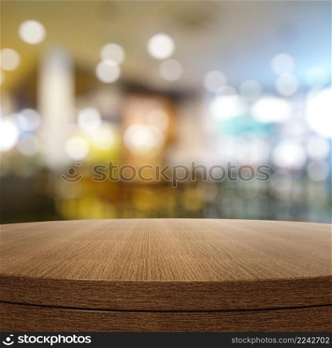 Empty wooden round table and blurred background for product presentation
