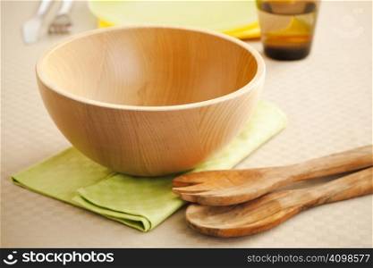 Empty wooden salad bowl on the kitchen table