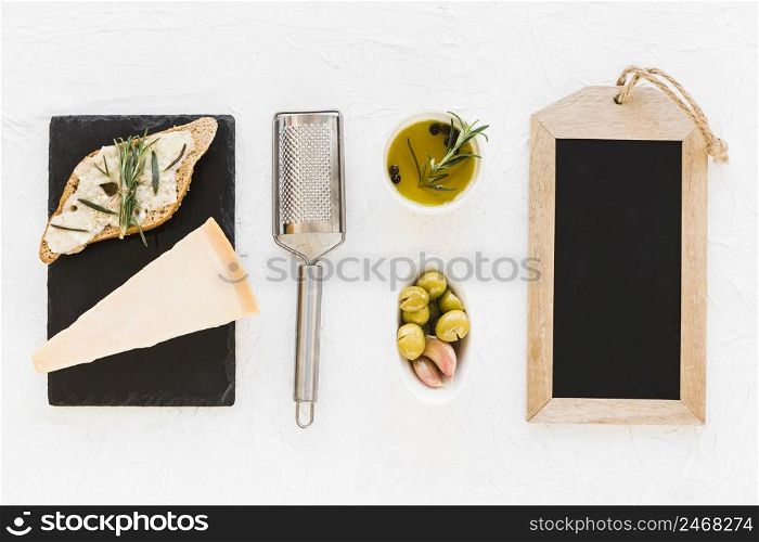 empty wooden slate frame with olive cheese white background
