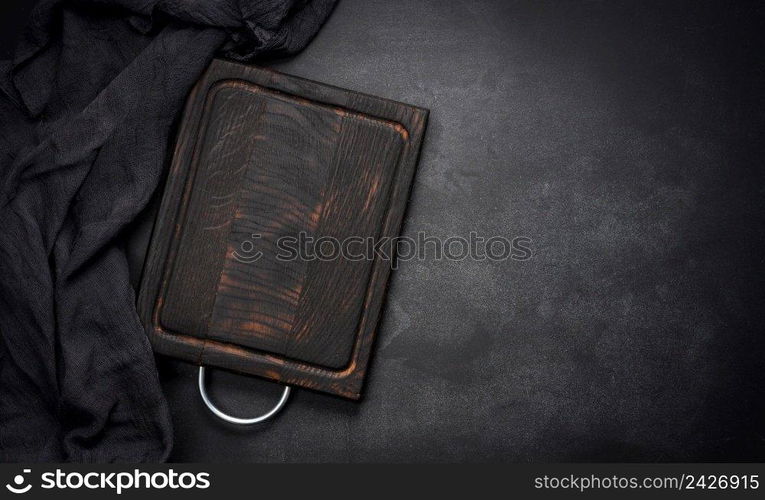 empty wooden square cutting board on black table, food display template, top view