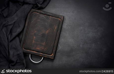 empty wooden square cutting board on black table, food display template, top view